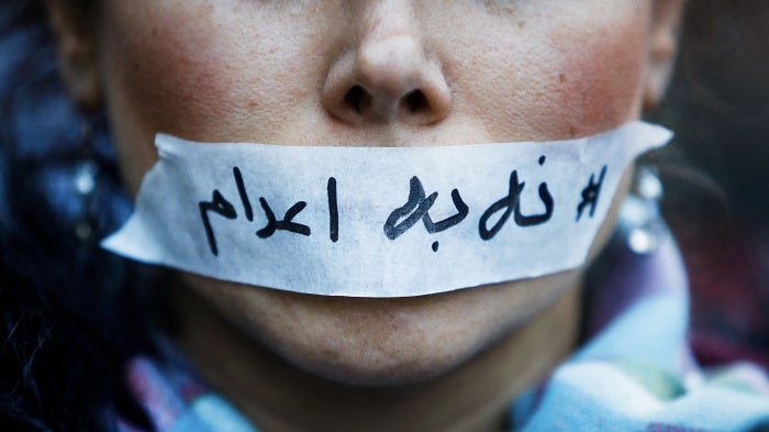 A person's mouth covered with tape bearing a message “no to executions” in Iran, in Paris in France, January 31, 2026.