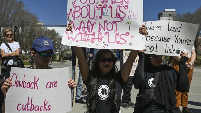 Participants hold placards during the Act NOW Rally hosted by Barrier-Free Alberta in front of the Alberta Legislature, Canada, May 6, 2025.