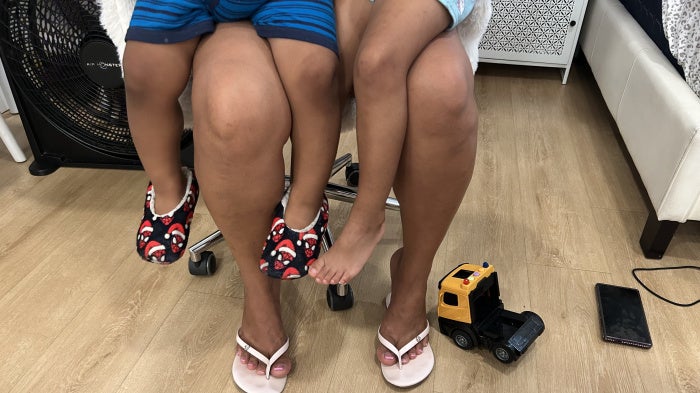 An asylum seeker who has lived in the US for four years holds her two US citizen children, ages 2 and 4, in her lap, September 2026. 