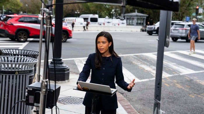 MS NOW White House Correspondent Akayla Gardner prepares for a television report on a street corner outside the White House grounds in Washington, DC, on September 21, 2026.
