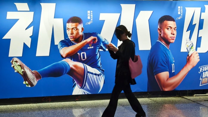An advertisement featuring French soccer star Kylian Mbappé in Shanghai, China, June 30, 2026.