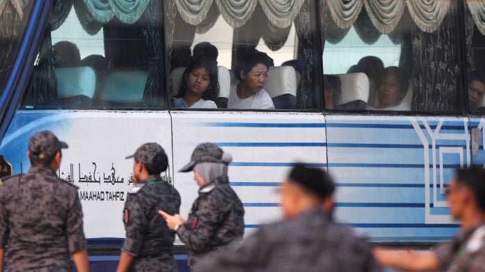Myanmar nationals to be repatriated from Malaysia sit inside a bus, at Lumut, Malaysia, September 29, 2026.