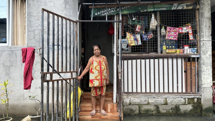 Aidaliza Aquino spends most of her time indoors because of the daily flooding at the Pulo relocation site in Barangay Candelaria, Macabebe, Pampanga, Philippines, July 13, 2026. 