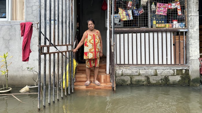 Aidaliza Aquino spends most of her time indoors because of the daily flooding at the Pulo relocation site in Barangay Candelaria, Macabebe, Pampanga, Philippines, July 13, 2026. 