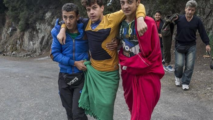 18-year-old Mohammed, who said he lost both legs to a Syrian airstrike in Idlib in 2012, is carried by friends on the island of Lesbos in Greece. Both his friends and parents accompanied him on his journey to safety, carrying him whenever needed.