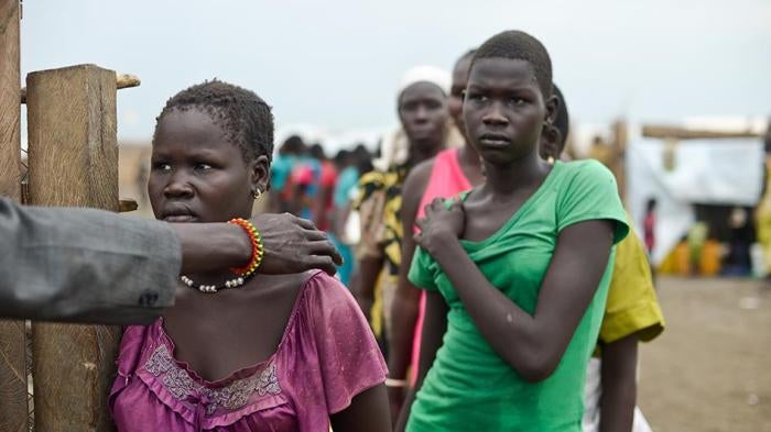 A woman at the front of a line for water in the UNMISS camp near Bentiu is directed to an enclosed water pumping area where demand is high and women must wait in long lines, sometimes for hours even before dawn. 