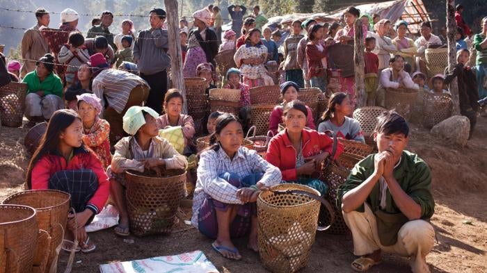Displaced Kachin civilians living in temporary shelter in KIA-controlled territory in eastern Kachin State, wait for rations of rice and cooking oil, January 26, 2012. 