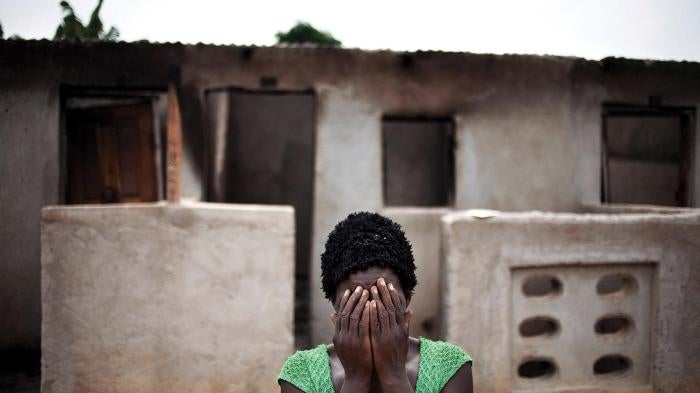 A woman hides her face after recounting how pro-Ouattara forces killed two of her children and her brother during the post-election violence in Duékoué, western Côte d’Ivoire.