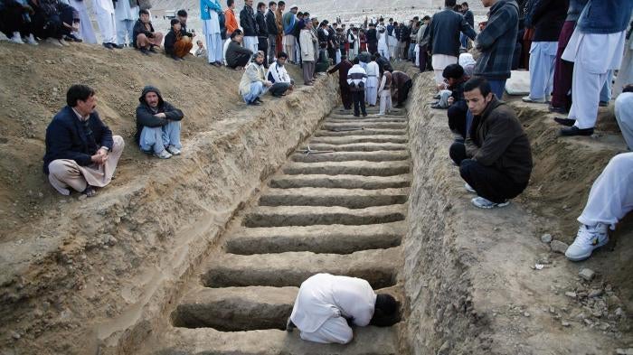 A man prepares graves for the victims of the February 17, 2013 vegetable market bomb attack in a Shia Hazara area of Quetta city in Pakistan.