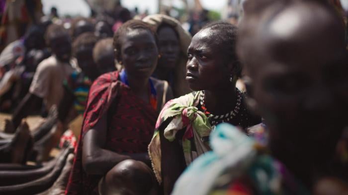 Women from the Murle tribe wait to receive emergency food aid in Pibor town. 