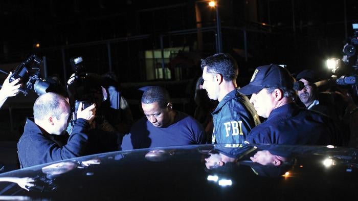 Federal agents and police escort James Cromitie (center) from the FBI’s New York headquarters on May 21, 2009.