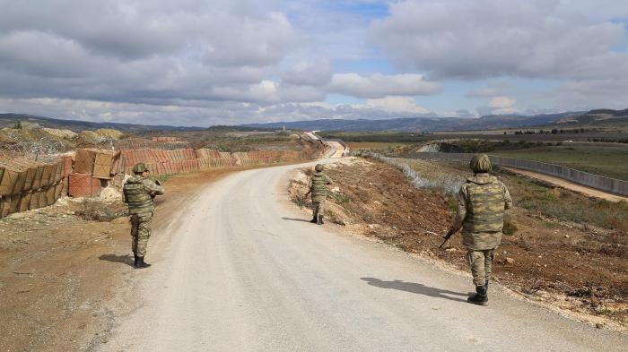 Turkish soldiers patrol in Hatay province along Turkey's new border wall with Syria in February 2016.