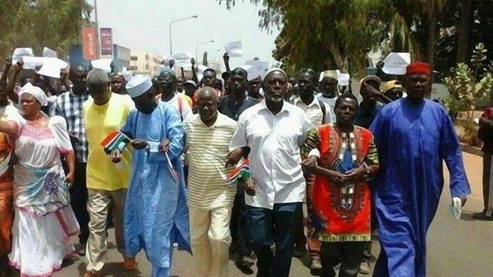 Protesters march in Banjul on April 16, 2016 following the death in custody of opposition activist Solo Sandeng.