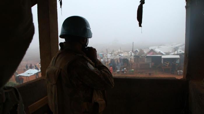 A United Nations peacekeeper in Kaga-Bandoro, Central African Republic, looks out over the new displacement camp near the airstrip that formed after the October 12 attack.  