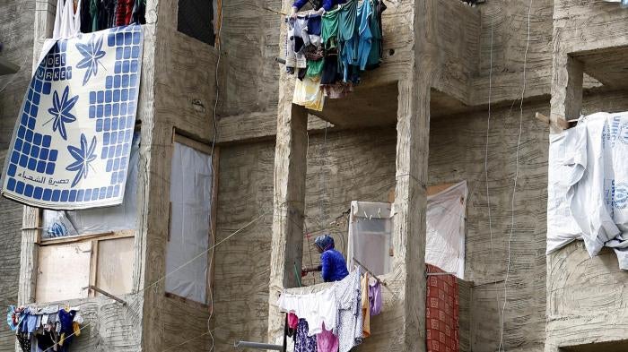 Syrian women hang clothing on their balconies inside a compound for Syrian Refugees in Sidon, south Lebanon April 17, 2015. 
