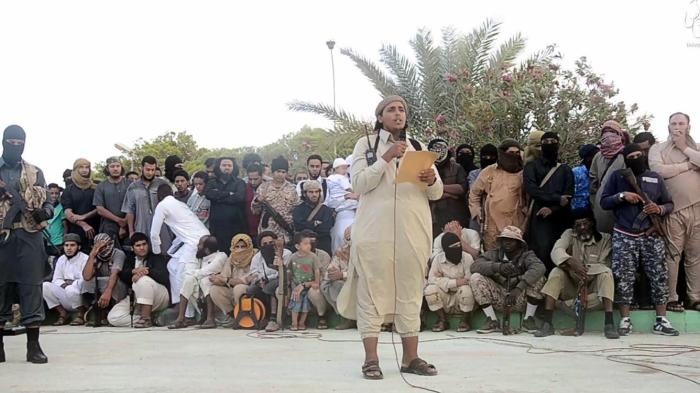 An ISIS official makes an announcement ahead of the execution of two men for “sorcery” in Sirte, Libya. Image from a 2015 Islamic State (ISIS) video. The online clearinghouse Jihadology.net posted the video on its website.