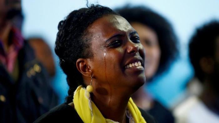 A woman cries as she attends a prayer session at Biftu Bole Lutheran Church during a prayer and candle ceremony for those who died in the town of Bishoftu during Ireecha, the thanksgiving festival for the Oromo people, Addis Ababa, Ethiopia, October 9, 20