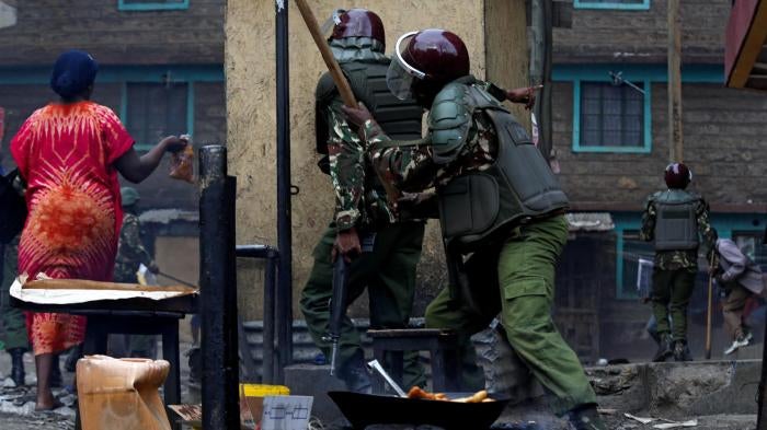  Residents flee as anti-riot policemen pursue opposition protestors in Mathare, Nairobi, on August 12. 