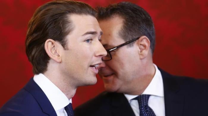 Head of the Freedom Party Heinz-Christian Strache (R) and head of the People's Party Sebastian Kurz react during the swearing-in ceremony of the new government in Vienna, December 18, 2017