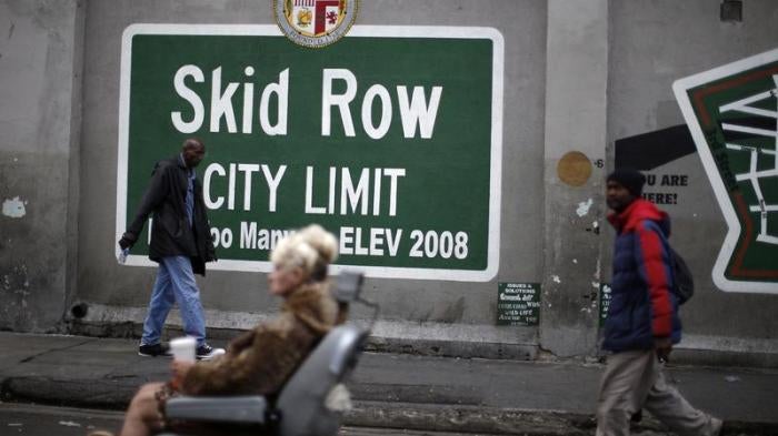 People view a memorial for a man killed by police on skid row in Los Angeles, California, March 2, 2015.