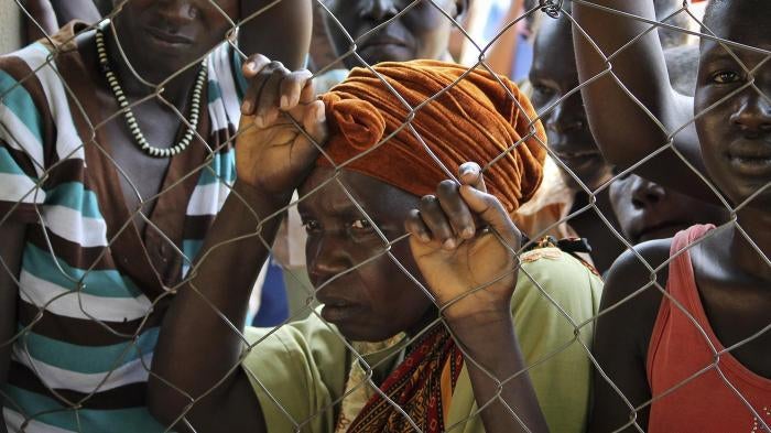 Women stand outside a UN Refugee Agency (UNHCR) site in Yei