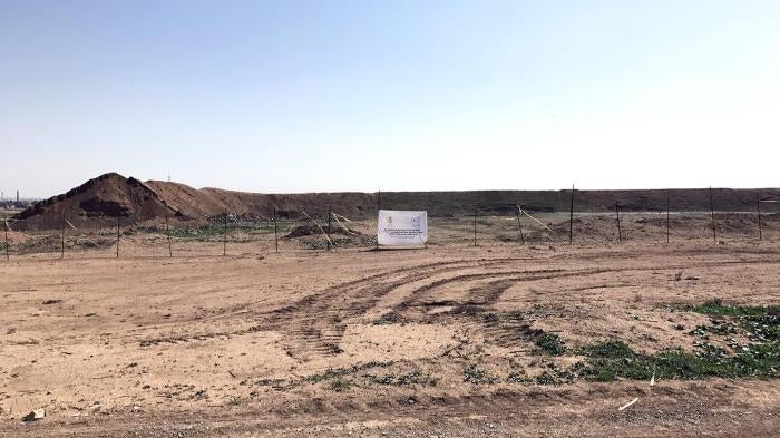 ‘Hammam al-Alil mass grave marked and fenced’ Caption: A marked and fenced ISIS mass grave in Hammam al-Alil, 30 kilometers south of Mosul, discovered in November 2016.