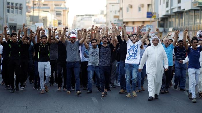 Mourners shouting anti-government slogans during the funeral procession of Hassan Al Hayki, who was arrested in connection with a car bombing. Al Hayki died while in detention in Manama, August 2, 2016. 