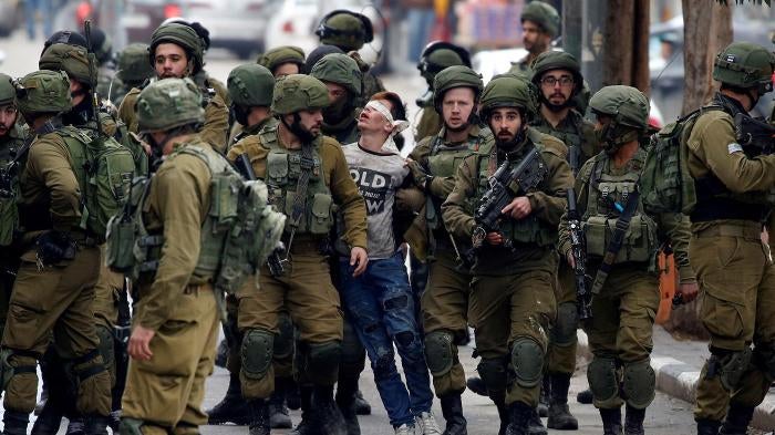 Israeli soldiers detain 16-year-old Fawzi al-Junaidi in Hebron amid protests in December over the US decision to recognize Jerusalem as the capital of Israel.