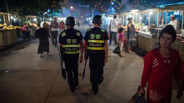 Chinese police patrol a night market near Id Kah Mosque in Xinjiang, a day before the Eid al-Fitr holiday, June 25, 2017.