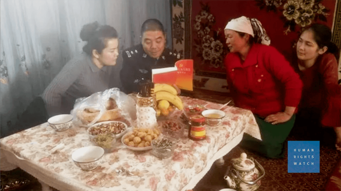Chinese officials visit a Muslim family.
