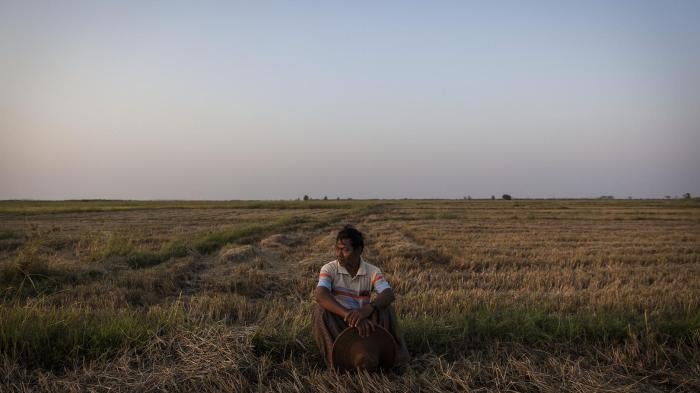 La Win, 61, a farmer from the Ayeyarwady Region, sits on a portion of the 35 acres of land he said was taken from him in 2004 by a company. When asked about the effect of the seizure of the land he said, “I suffered great losses in every aspect of my life