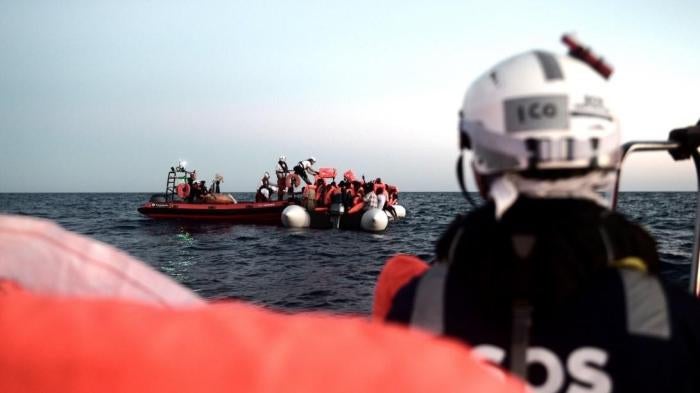SOS MEDITERRANEE crew rescue people off an over-crowded rubber boat in the Mediterranean, June 9, 2018. 