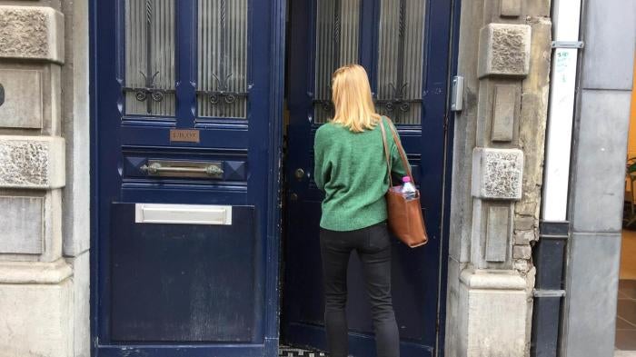 A woman entering a door
