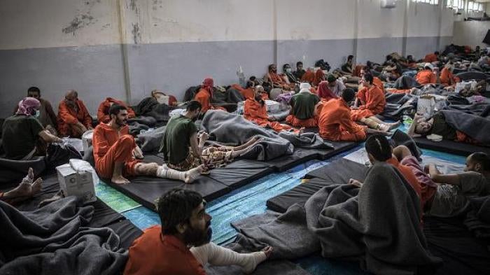 Men, suspected of being affiliated with the Islamic State, gather in a prison cell in the northeastern Syrian city of Hasakeh on October 26, 2019.  
