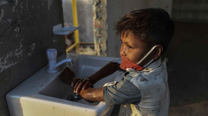 A child washing hands with anti-bacterial soap as a preventive measure against COVID-19, at Sadarghat Launch Terminal, in Dhaka, Bangladesh, on March 27, 2020.