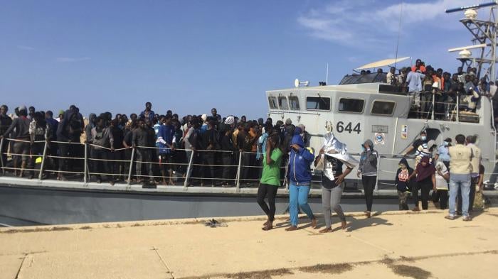Photo released by the Libyan Coast Guard showing people disembarking in Libya after being intercepted offshore, June 24, 2018. 