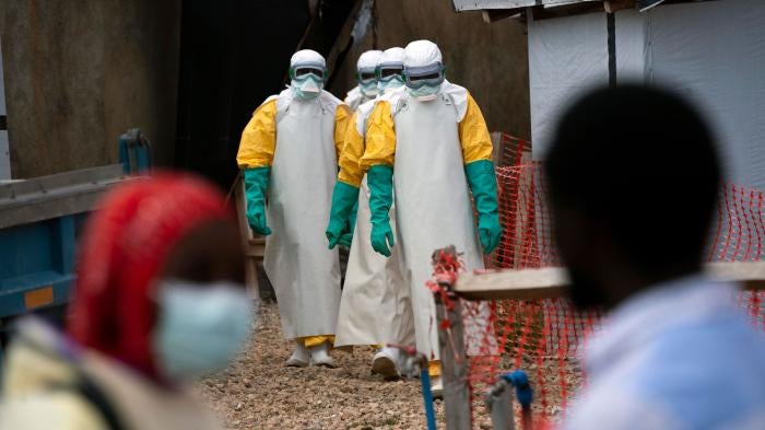 Health workers dressed in protective gear begin their shift at an Ebola treatment center in Beni, Democratic Republic of Congo, July 16, 2019.