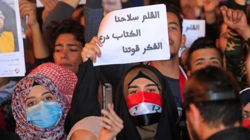 Woman holding up a sign in Arabic