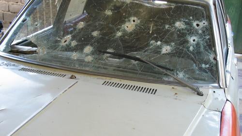 A car shot-up by US soldiers during the protest on April 28, 2003. The US military claimed that gunmen were using the car as cover, but protesters denied that any of them had opened fire.