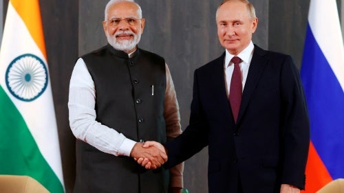 Russian President Vladimir Putin, right, and Indian Prime Minister Narendra Modi pose for a photo shaking hands prior to their talks on the sidelines of the Shanghai Cooperation Organisation (SCO) summit in Samarkand, Uzbekistan, on Sept. 16, 2022.