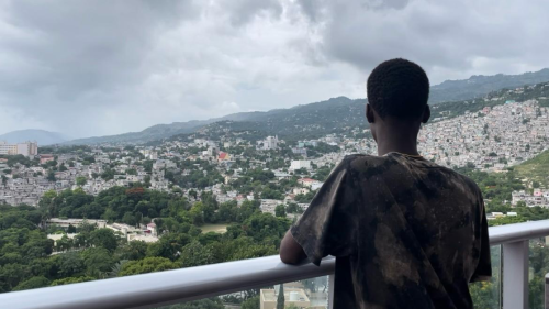 A 17-year-old Carrefour resident, associated with a criminal group, stands on a terrace, gazing out over the horizon in Port-au-Prince, Haiti, July 2024.