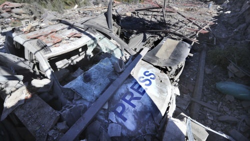 Two destroyed vehicles and a demolished building where three journalists were killed in an Israeli airstrike at the Hasbaya Village Resort, in sourthern Lebanon on October 25, 2024.