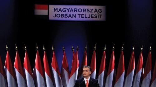 Hungarian Prime Minister Viktor Orban presents his annual state-of-the-nation speech in Budapest, February 22, 2013. The background reads : Hungary doing better.