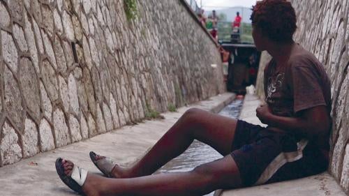 A homeless youth from the LGBT community sits in the sewer where he lives in Kingston, Jamaica. Rejected by their families and communities, many LGBT Jamaicans live on the streets, where they face violence and harassment.