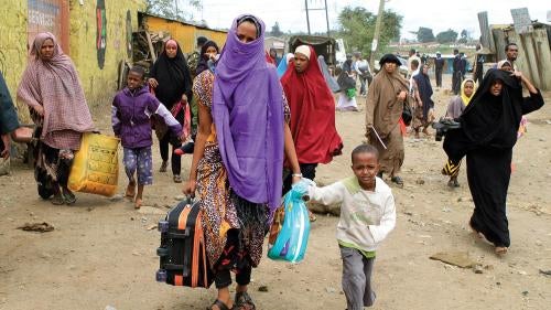 Somali women and children fleeing their homes in Nairobi’s predominantly Somali suburb of Eastleigh on November 20, 2012, two days after an attack on a bus by unknown perpetrators caused Kenyan gangs to riot and attack Somali refugees and Somali Kenyans. 