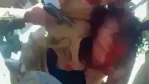 A still image taken from amateur video posted on a social media website and obtained by Reuters on October 21, 2011, shows former Libyan leader Muammar Gaddafi, held on the ground by opposition fighters in Sirte, with a gun pointed at his head.