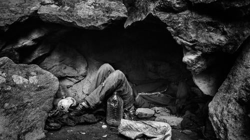 Nador, Morocco, November 2012 – A migrant from Mali lying down in a cave used as shelter. In the forests and mountains that surrounded Nador, groups of Sub-Saharan African migrants survive and wait for the right moment to attempt to cross the border.