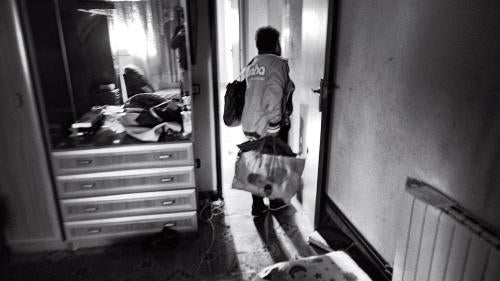 A woman picks up her clothes from her room after receiving an eviction notice in Terrassa, Spain, October 19, 2012.