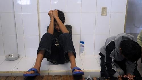 A 12-year-old Salvadoran boy rests as he waits to be deported, at the National Immigration Institute, in Comitan, Chiapas, Mexico on August 19, 2010. ©2010 Jose Cabezas/AFP/Getty Images