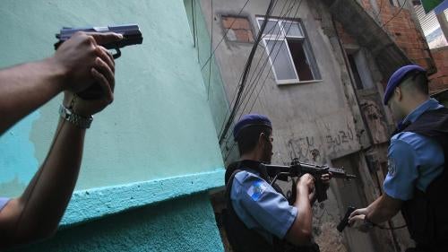 Policemen patrol the Rocinha favela in Rio de Janeiro on September 14, 2012. 